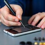 Technician replacing smartphone battery